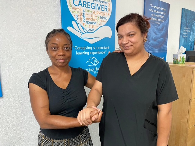 Two caregivers practicing Hand-under-Hand ® connection